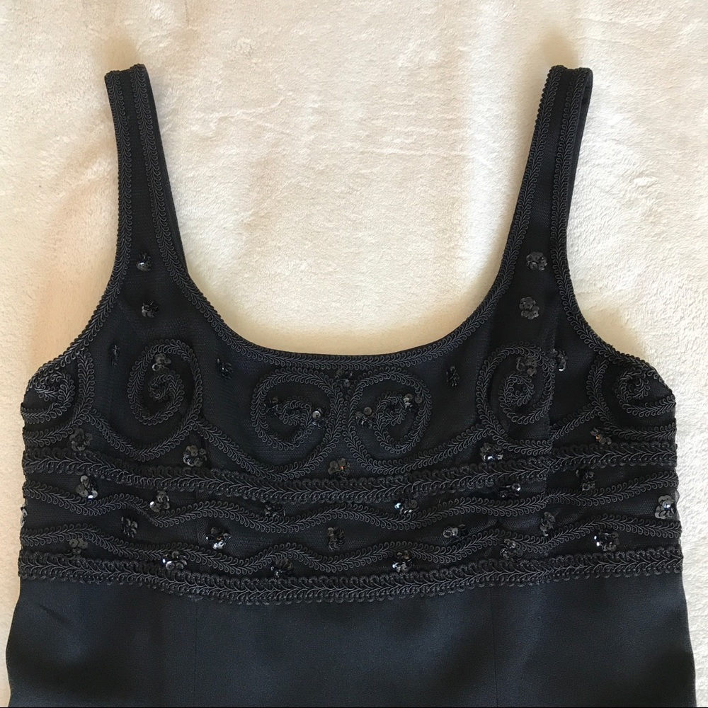 Black sleeveless evening dress with beaded top.